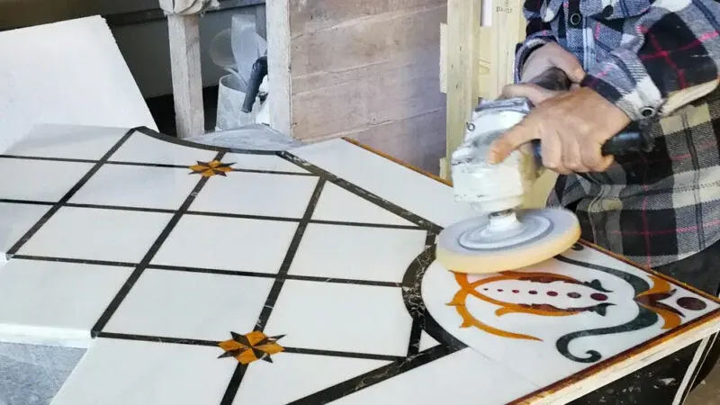 Hand polishing a marble surface with a soft cloth at home